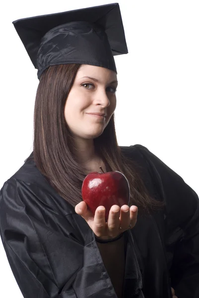Junge Absolventin hält Apfel — Stockfoto