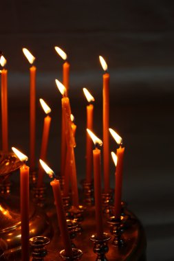 Burning candles in Christian church clipart