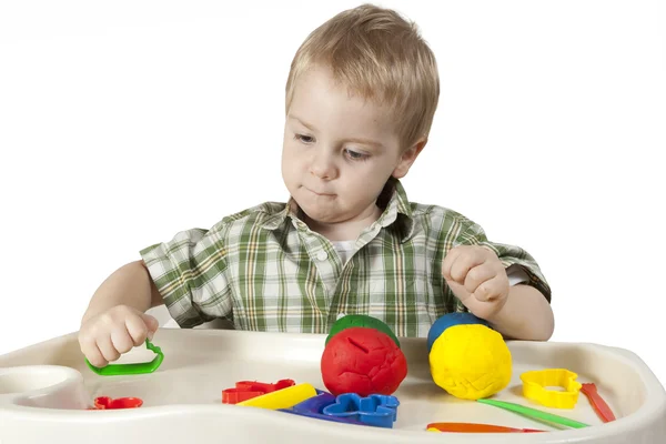 Happy child playing with plasticine — Stock Photo, Image