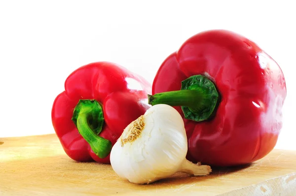 Two red peppers and a clove of garlic — Stock Photo, Image