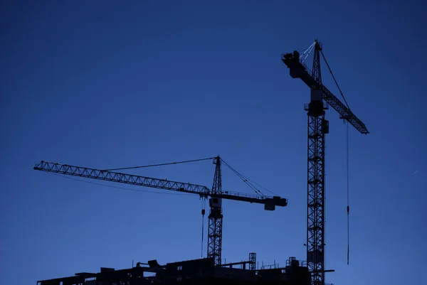 Construction cranes at dusk — Stock Photo, Image