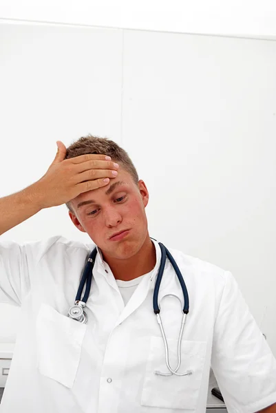 Tired young male doctor — Stock Photo, Image