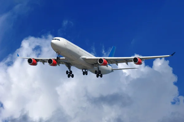 Vliegtuig en blauw wolken — Stockfoto