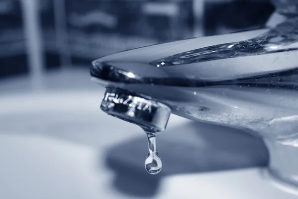 stock image Water drop falling form a faucet