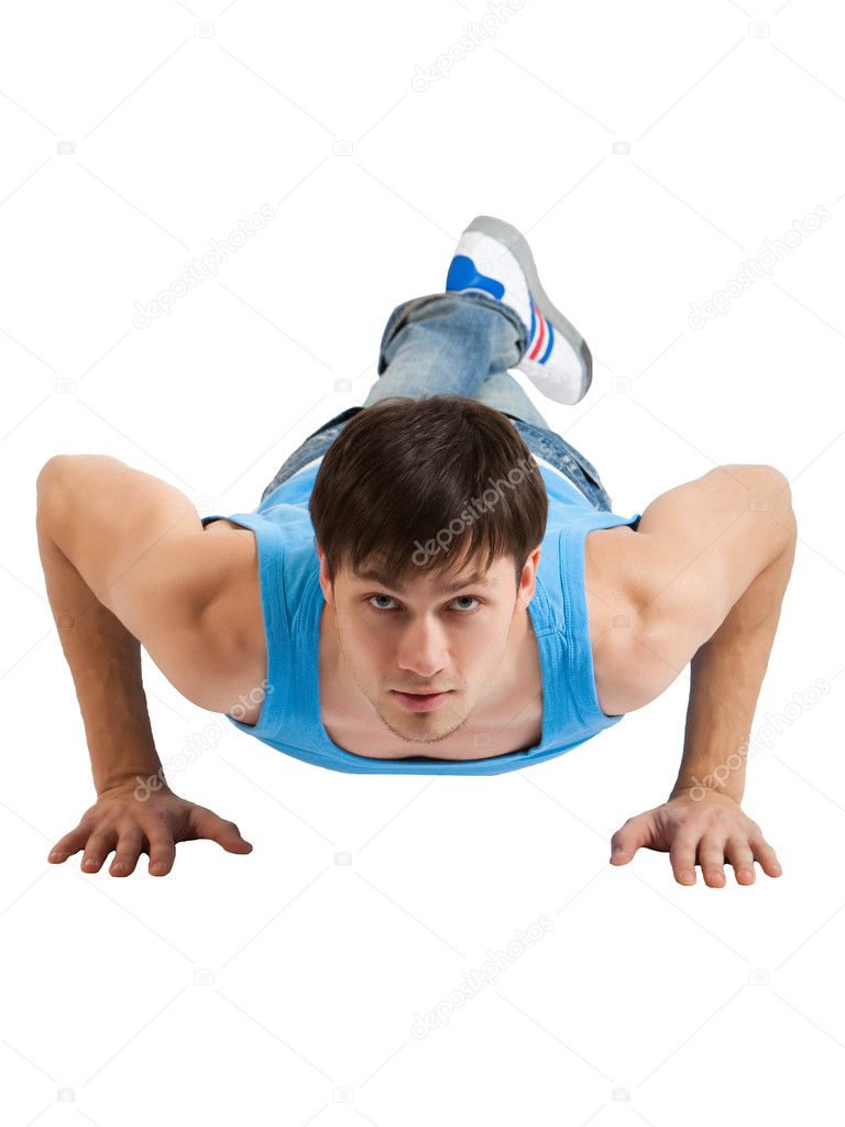 Young man making push-ups. Isolated