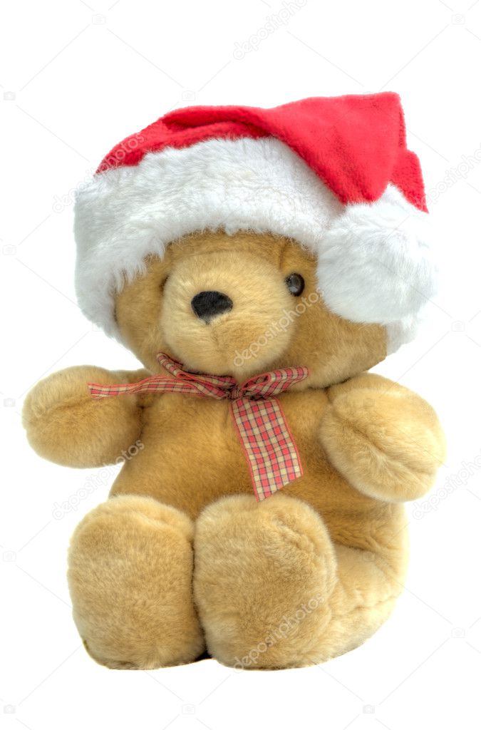 A child's teddy bear wearing a santa hat