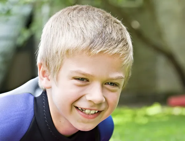 Åtta år gammal pojke ler mot kameran — Stockfoto