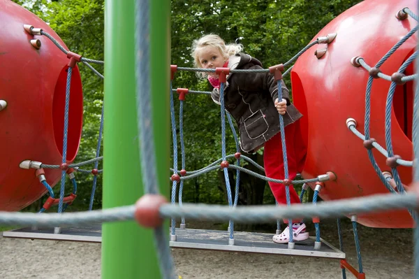 Climbing girl at the playground — Stock Photo, Image