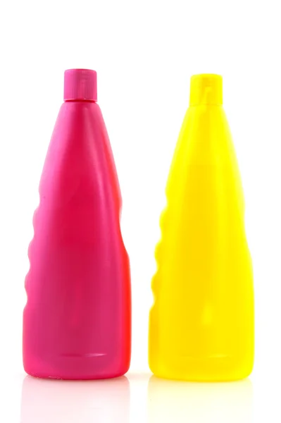 Pink and yellow shampoo bottles — Stock Photo, Image