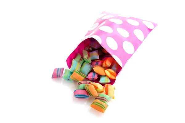 Doces coloridos em saco de papel — Fotografia de Stock