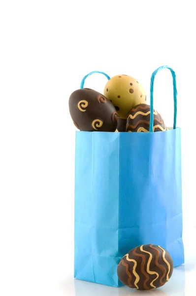 Blue bag filled with easter eggs — Stock Photo, Image
