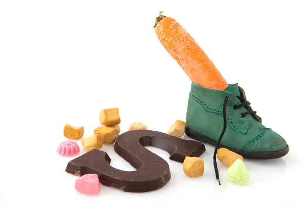 Shoe with carrot and candy — Stock Photo, Image