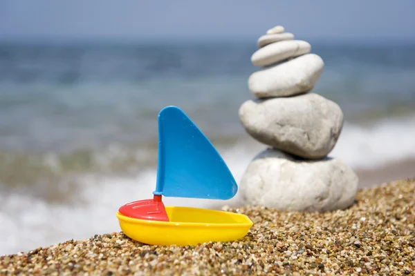 Toys and stacked pebbles — Stock Photo, Image