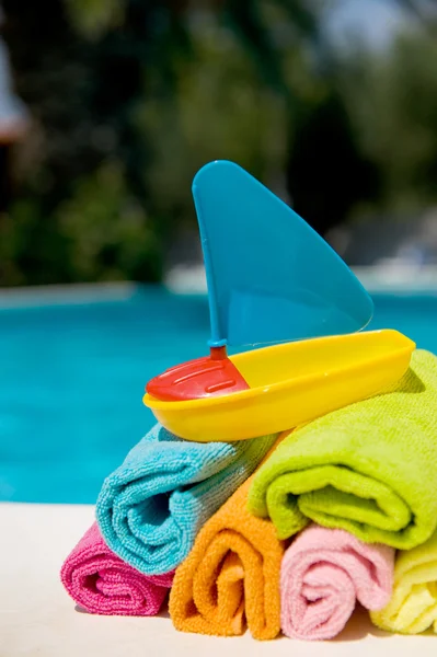 Rolled towels and toys — Stock Photo, Image