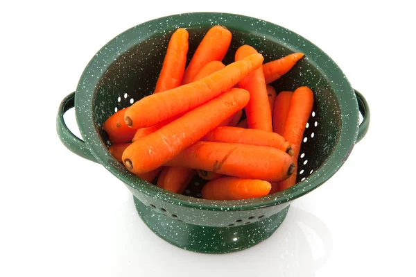 Green colander with fresh carrots — Stock Photo, Image