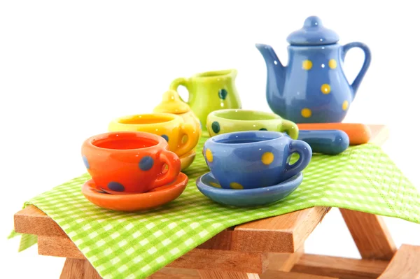 Wooden picnic table with crockery — Stock Photo, Image
