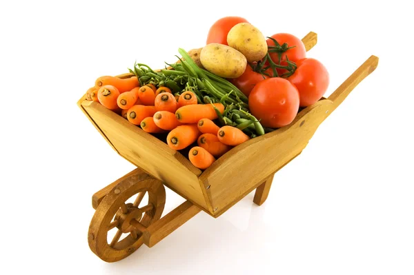 Wooden wheelbarrow with vegetables — Stock Photo, Image