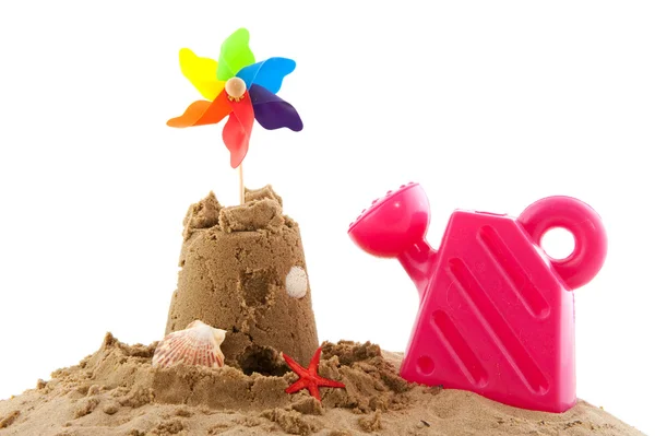 Sand castle and toys at the beach — Stock Photo, Image