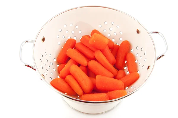 White colander with carrots — Stock Photo, Image