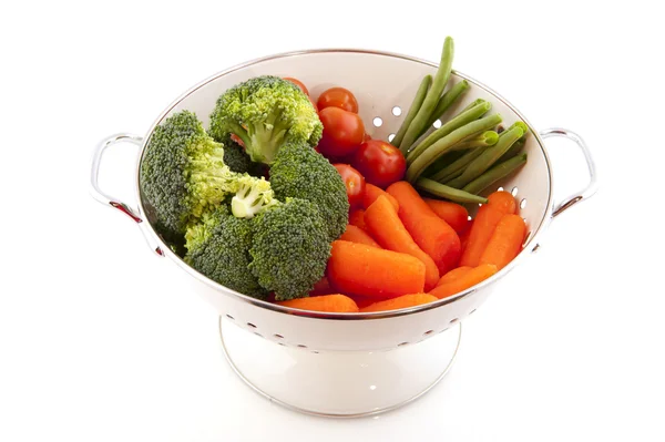 White colander with vegetables — Stock Photo, Image