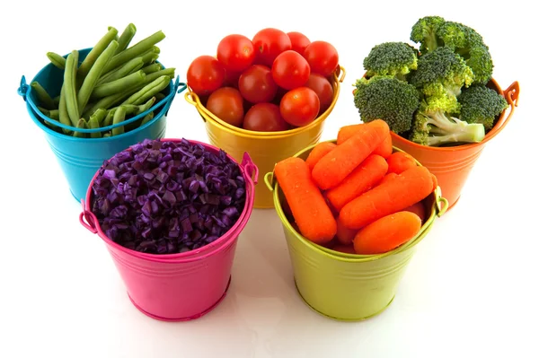 Fresh vegetables in colorful buckets — Stock Photo, Image