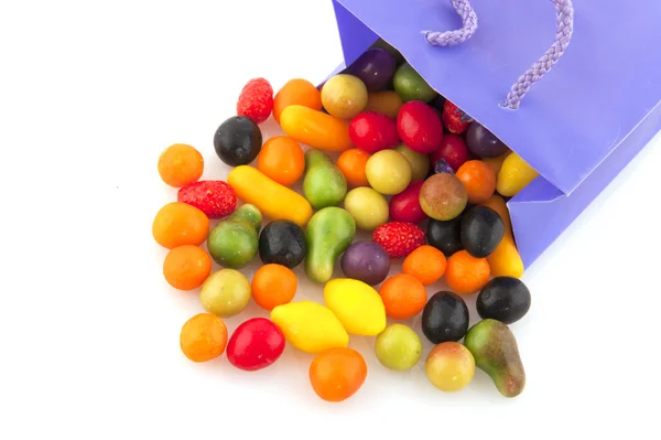 Colorful candy in purple bag — Stock Photo, Image