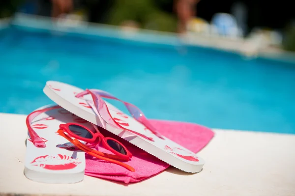 Flip flops near the swimming pool — Stock Photo, Image