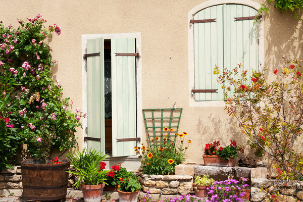 Romantic French house with blinds and flowers