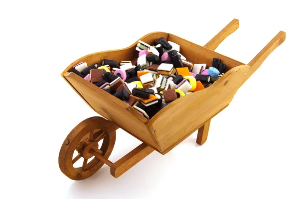 Wheel barrow with candy — Stock Photo, Image