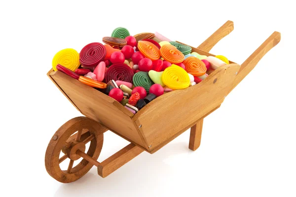 Wheel barrow with lots of candy — Stock Photo, Image