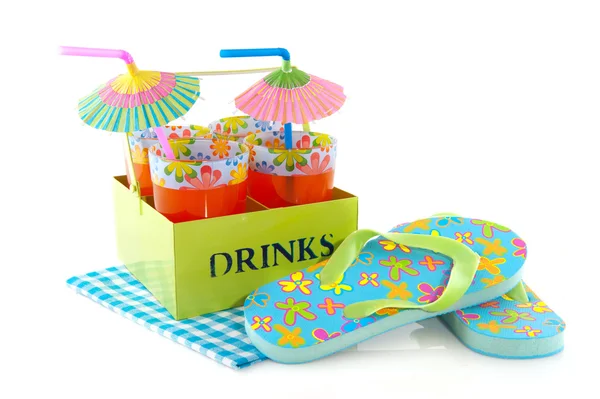 Glasses orange lemonade and flip flops — Stock Photo, Image