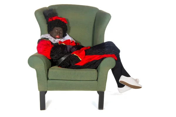 Schwarzer Piet faul im Stuhl — Stockfoto