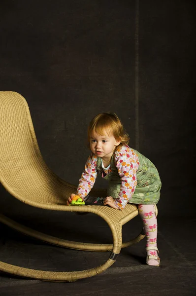 Девушка играет на кресле — стоковое фото