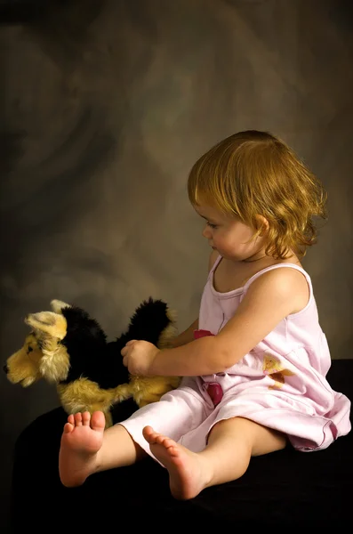 Дівчина грає з іграшковим собакою — стокове фото