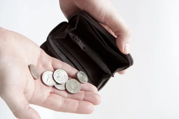 Pouring coins into empty wallet — Stock Photo, Image