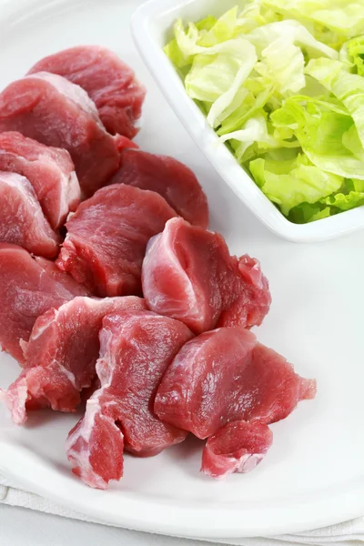 Raw pork meat with iceberg lettuce — Stock Photo, Image