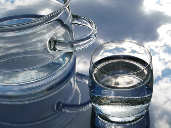 Glass pot and glass with water — Stock Photo, Image