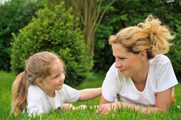 Young mother and daughter on the grass — Stock Photo, Image
