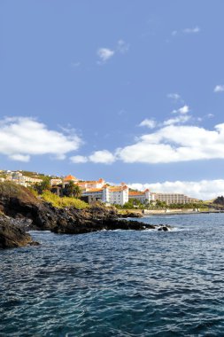 Resort by a rocky beach in Canico de Baixo, hotel Oasis Atlantic, Madeira. clipart