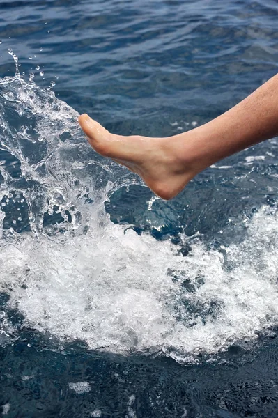 Fuß des jungen Mannes im Wasser - Platsch — Stockfoto