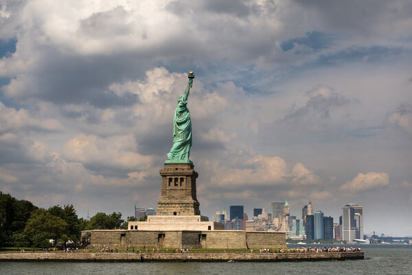 Statue of Liberty in New York City, under blue sky