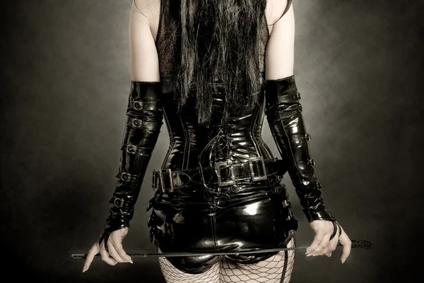 Vrouw in zwarte latex korset — Stockfoto