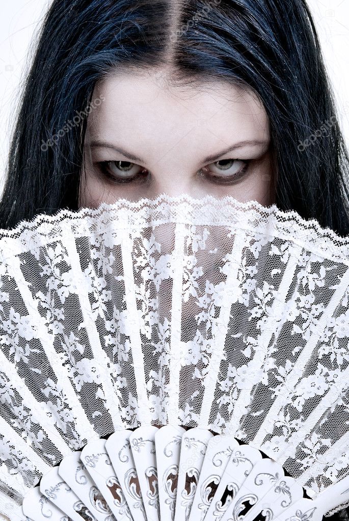Woman hidden behind a fan