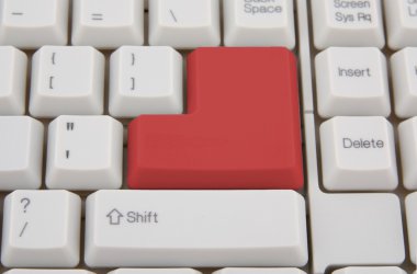 Computer keyboard with red Enter key clipart