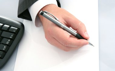 Businessman with pen on empty pape clipart