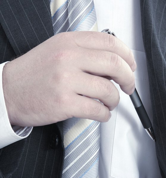 Hand removing a pen from his inside pocket