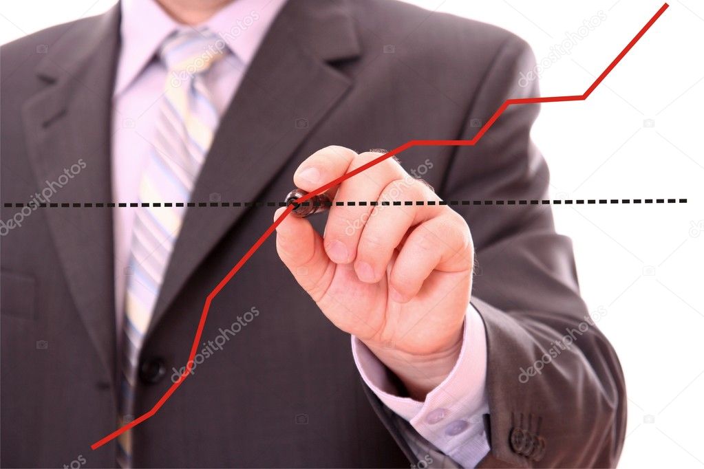 Businessman drawing a financial graph