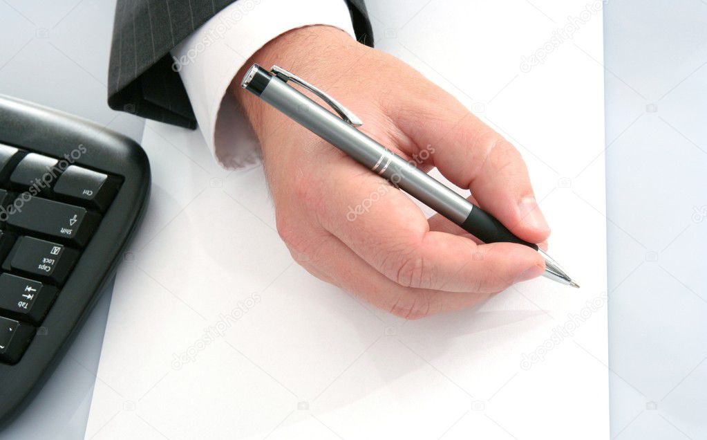 Businessman with pen on empty pape