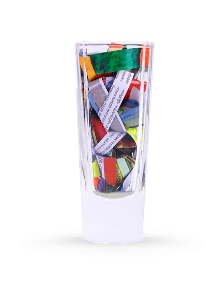 Glass with paper scraps — Stock Photo, Image
