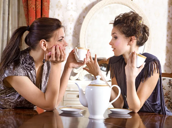 Twee mooie meisje-vrienden drinken thee — Stockfoto